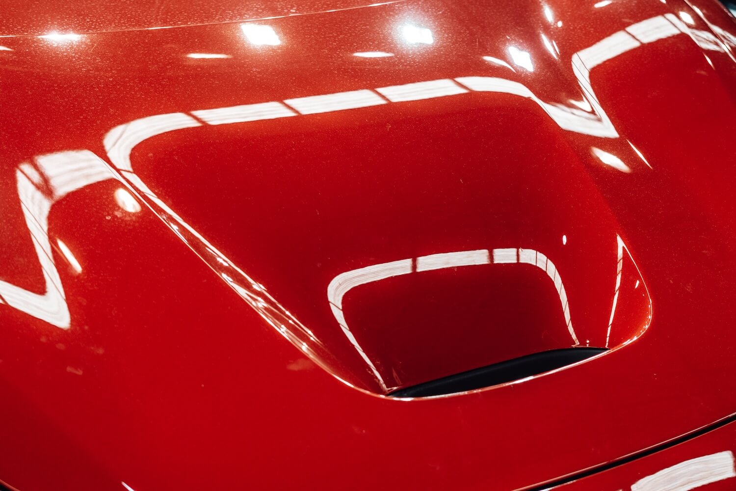 Exhaust on the hood of a red sports car 2026 03 13 04 22 30 utc.jpg