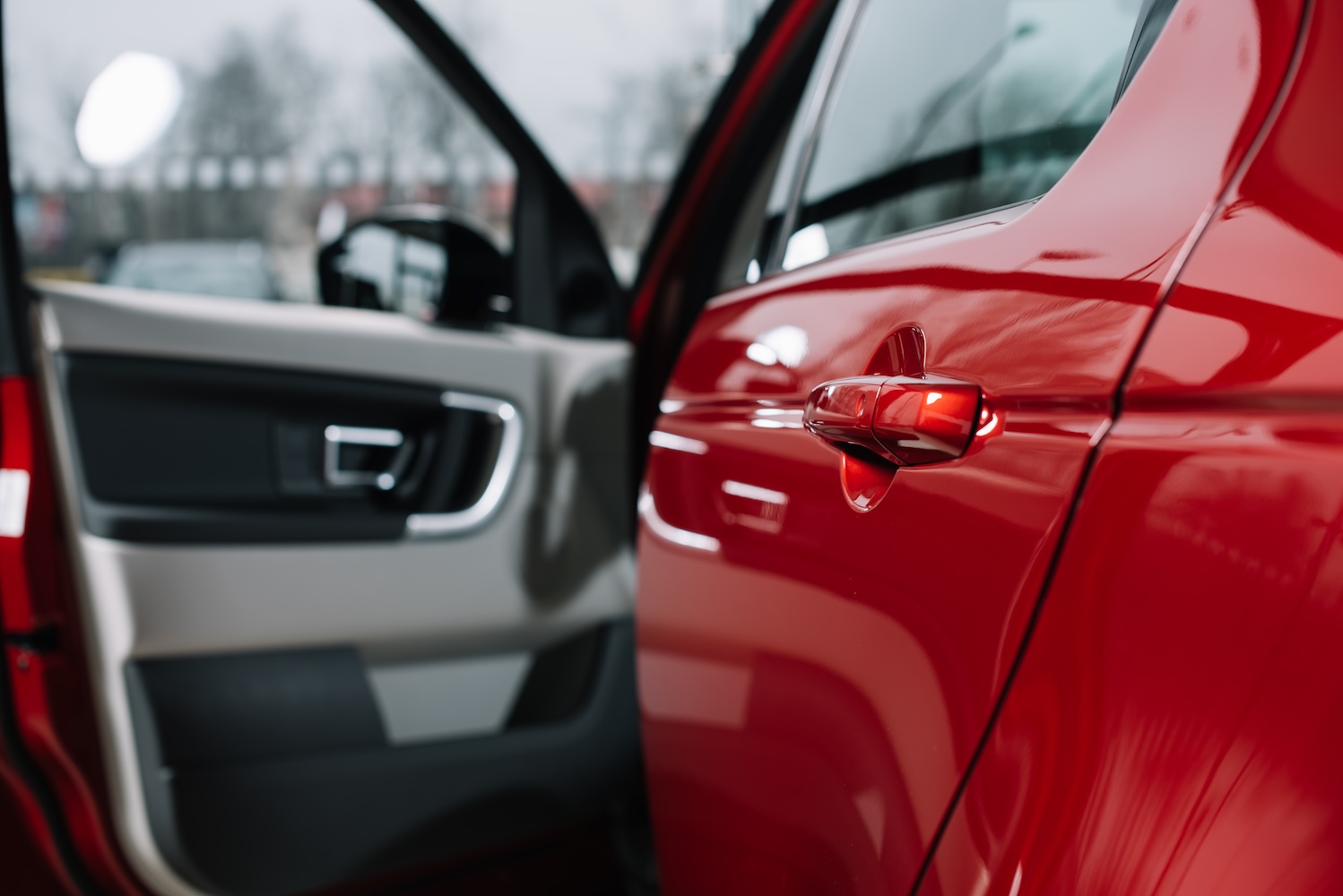 Open car door on a shiny red vehicle 2026 03 12 22 47 15 utc.jpg